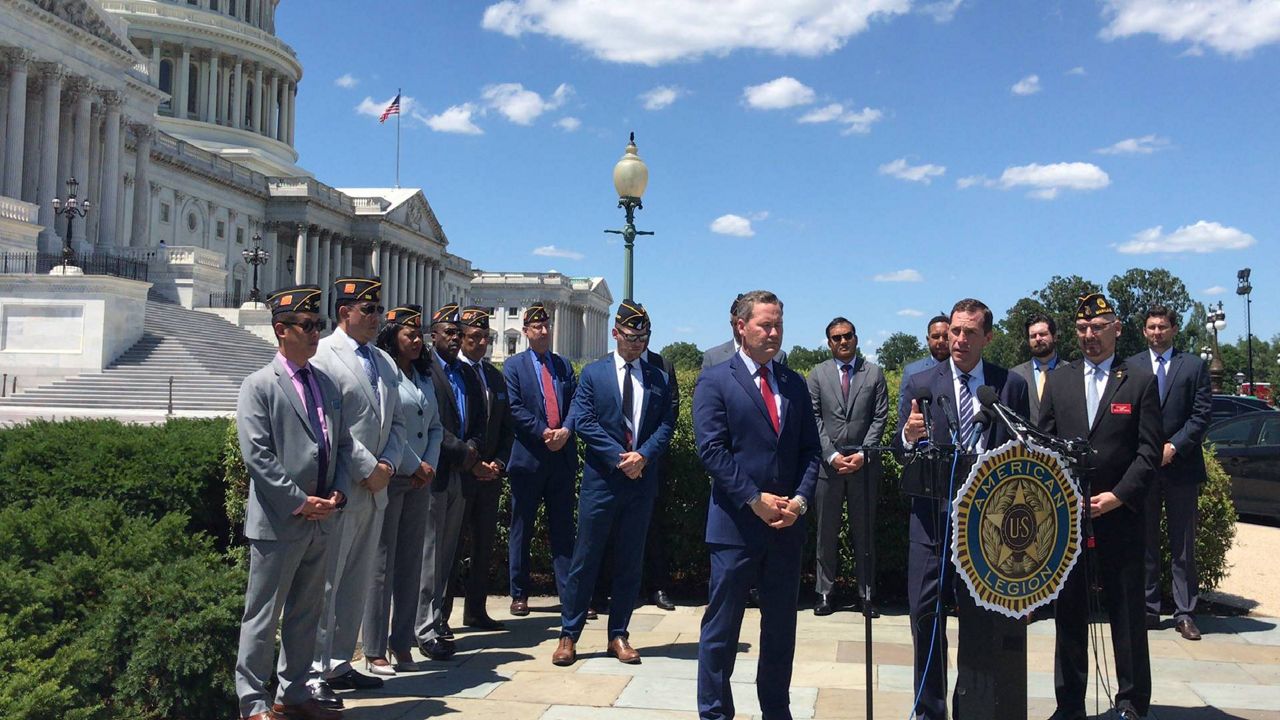 Reps. Jason Crow, D-Co., and Michael Waltz, R-Fla., speak at a press conference on Capitol Hill in support of Afghan interpreters, hosted by veterans group American Legion. (Austin Landis/Spectrum News)