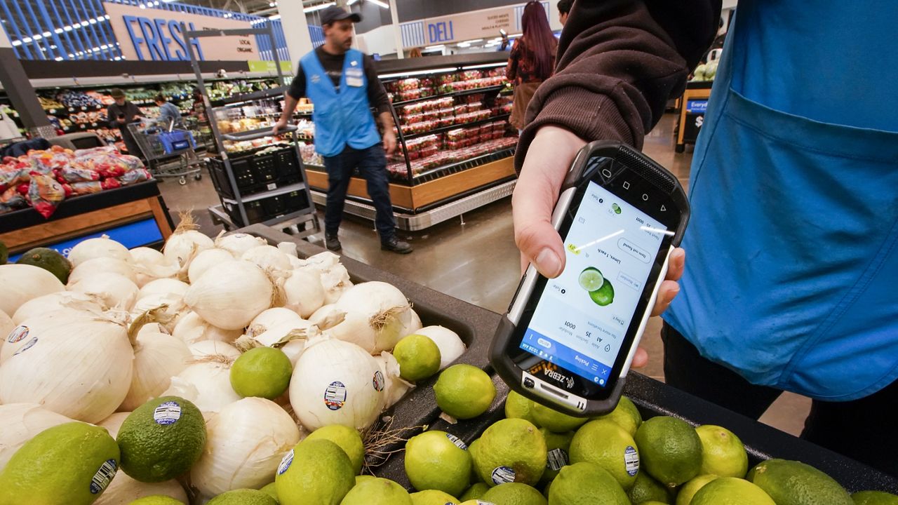 A worker scans onions, limes and other produce inside a Walmart Supercenter in North Bergen, N.J., on Feb. 9. (AP Photo/Eduardo Munoz Alvarez, File)