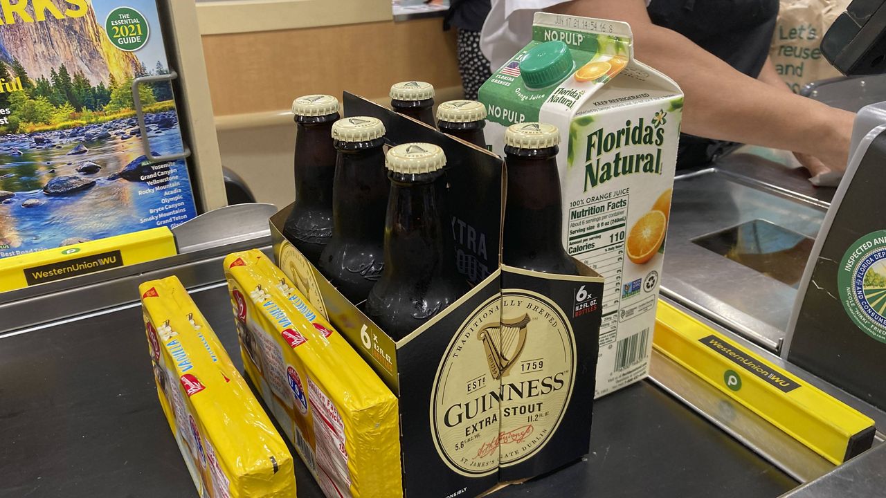 Groceries are shown at a checkout counter at a store in Surfside, Fla. (AP Photo/Wilfredo Lee)