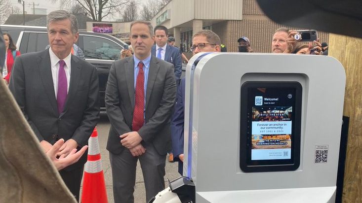 N.C. Gov. Roy Cooper attends the inauguration of an electrical vehicle charging station called the PoleVolt that uses streetlights in the Washington Heights neighborhood of Charlotte on Thursday. (Photo: Kari Beal)