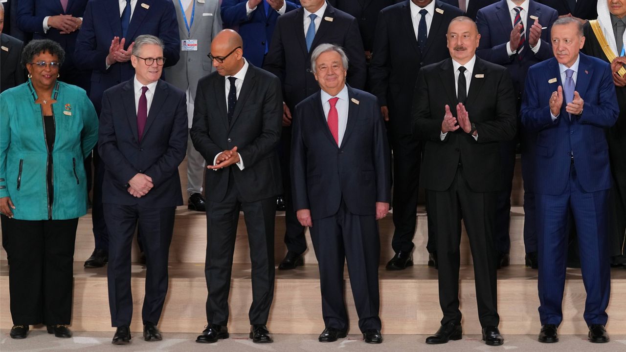 From left, Barbados Prime Minister Mia Mottley, United Kingdom Prime Minister Keir Starmer, United Nations climate chief Simon Stiell, U.N. Secretary-General Antonio Guterres, Azerbaijan PresidentI lham Aliyev and Turkey President Recep Tayyip pose with others for a group photo at the COP29 U.N. Climate Summit, Tuesday, Nov. 12, 2024, in Baku, Azerbaijan. (AP Photo/Peter Dejong)