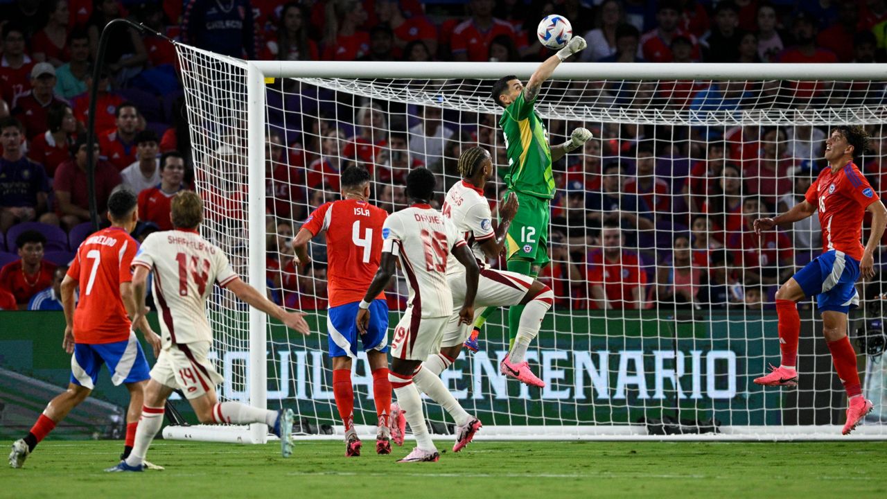 Chilean goalkeeper Gabriel Arias punches the ball away during a Copa America Group A soccer match against Canada in Orlando on Saturday, June 29, 2024. (AP Photo/Phelan Ebenhack)