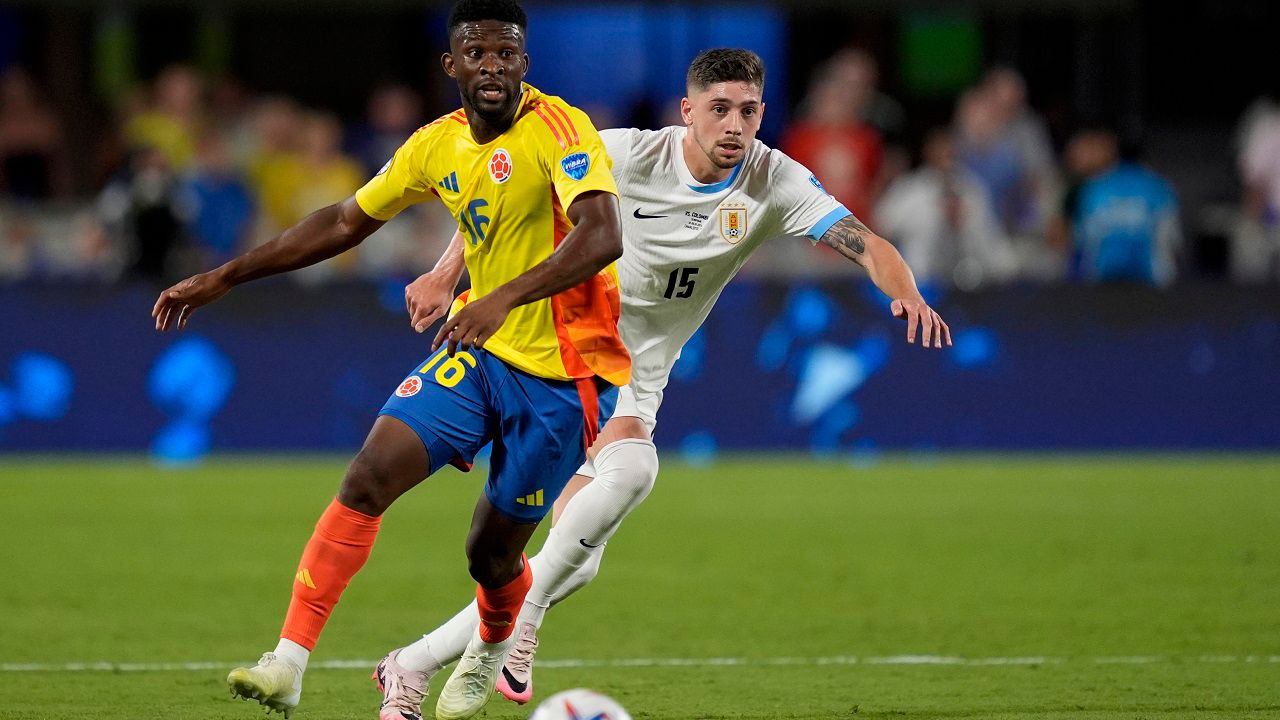 Colombia's Jefferson Lerma (16) and Uruguay's Federico Valverde battle for the ball during a Copa America semifinal soccer match in Charlotte, N.C., Wednesday, July 10, 2024. (AP Photo/Julia Nikhinson)