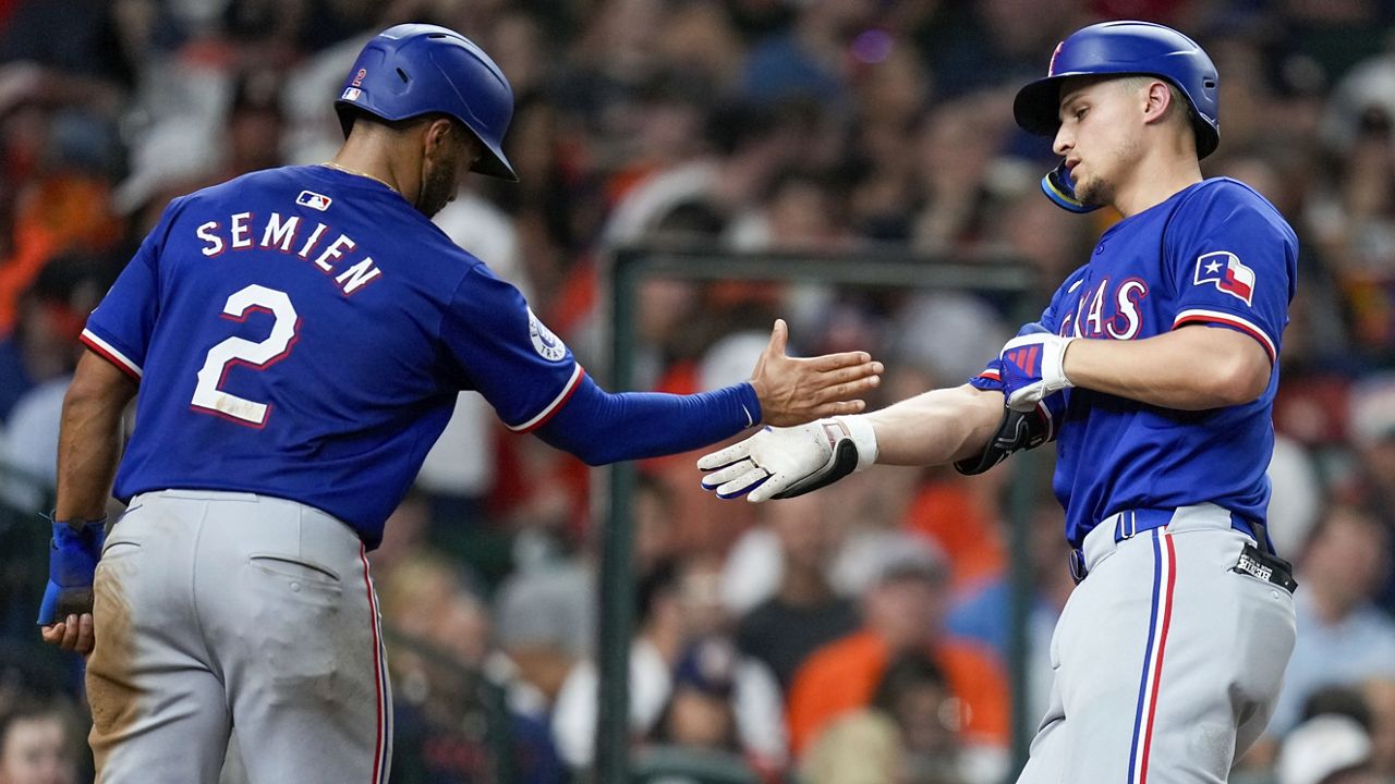 Texas Rangers' Corey Seager, right, celebrates after his two-run home run with Marcus Semien during the sixth inning of a baseball game against the Houston Astros, Friday, July 12, 2024, in Houston. (AP Photo/Eric Christian Smith)