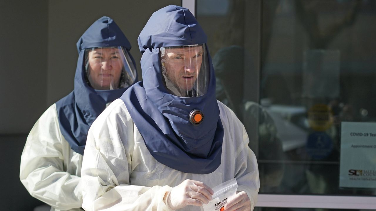 Salt Lake County Health Department public health nurses look on during coronavirus testing outside the department on Tuesday. (AP Photo/Rick Bowmer, File)