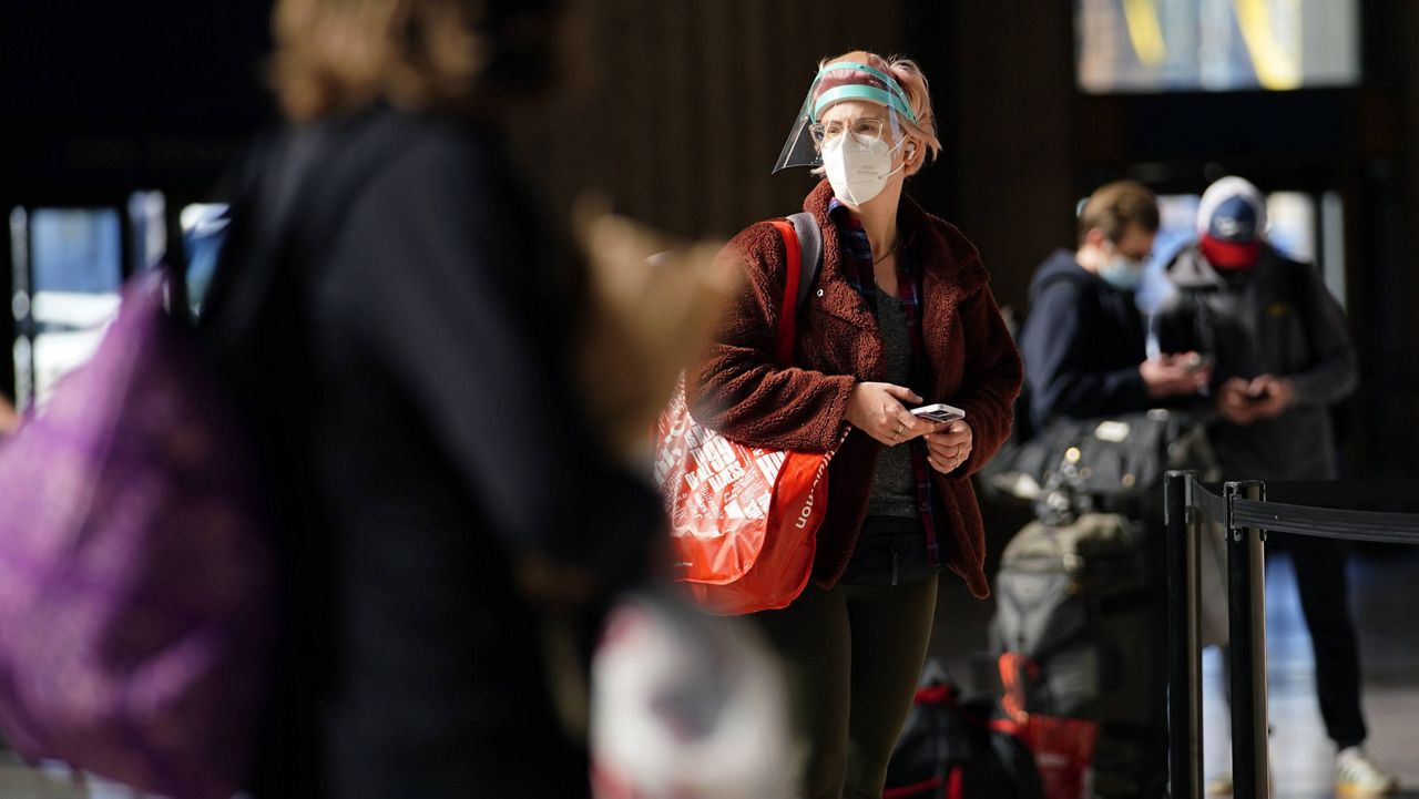 A woman waits in line for a train at the 30th Street Station in Philadelphia on Friday. (AP Photo/Matt Slocum)