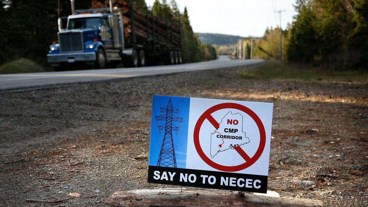 A sign with a protest message on Central Maine Power's controversial hydropower transmission corridor is displayed near Jackman, Maine.  If voters grant their approval on Tuesday, Nov. 7, 2023, Maine would be the 10th state to close the loophole in federal election law that bans foreign entities from spending on candidate elections, yet allows donations for local and state ballot measures. (AP Photo/Robert F. Bukaty, File)