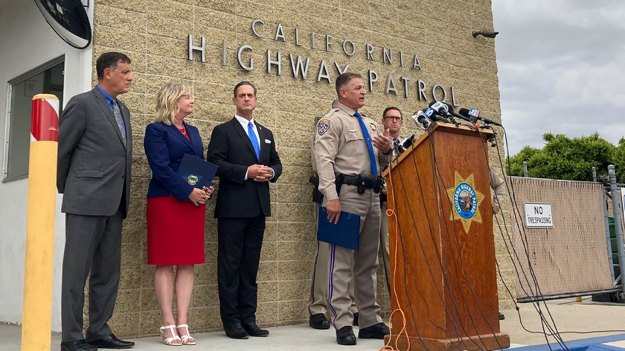 CHP Assistant Chief Don Goodbrand talks at the podium during a news conference Monday, June 7, 2021, and is joined by OC District Attorney Todd Spitzer third from left and other officials in Costa Mesa, Calif. (AP Photo/Amy Taxin)