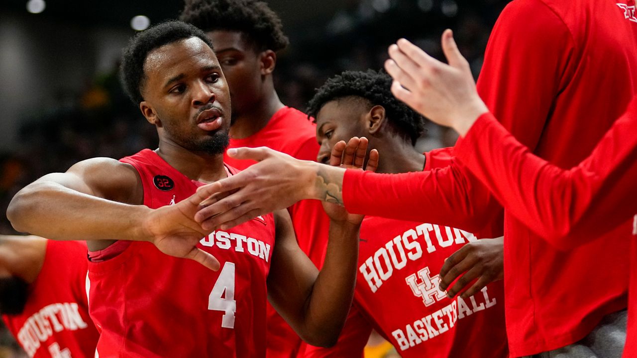 Houston guard L.J. Cryer (4) is greeted at the bench by teammates during the first half of an NCAA college basketball game against Baylor, Saturday, Feb. 24, 2024 in Waco, Texas. (AP Photo/Julio Cortez)