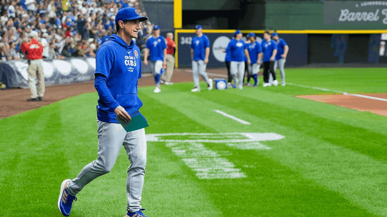 Chicago Cubs manager Craig Counsell walks out to exchange lineups before a baseball game against the Milwaukee Brewers