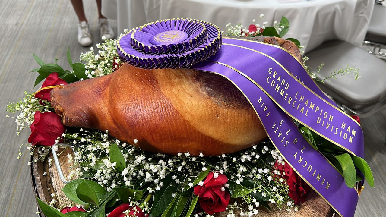 grand champion ham of the 2023 kentucky state fair sits atop flowers