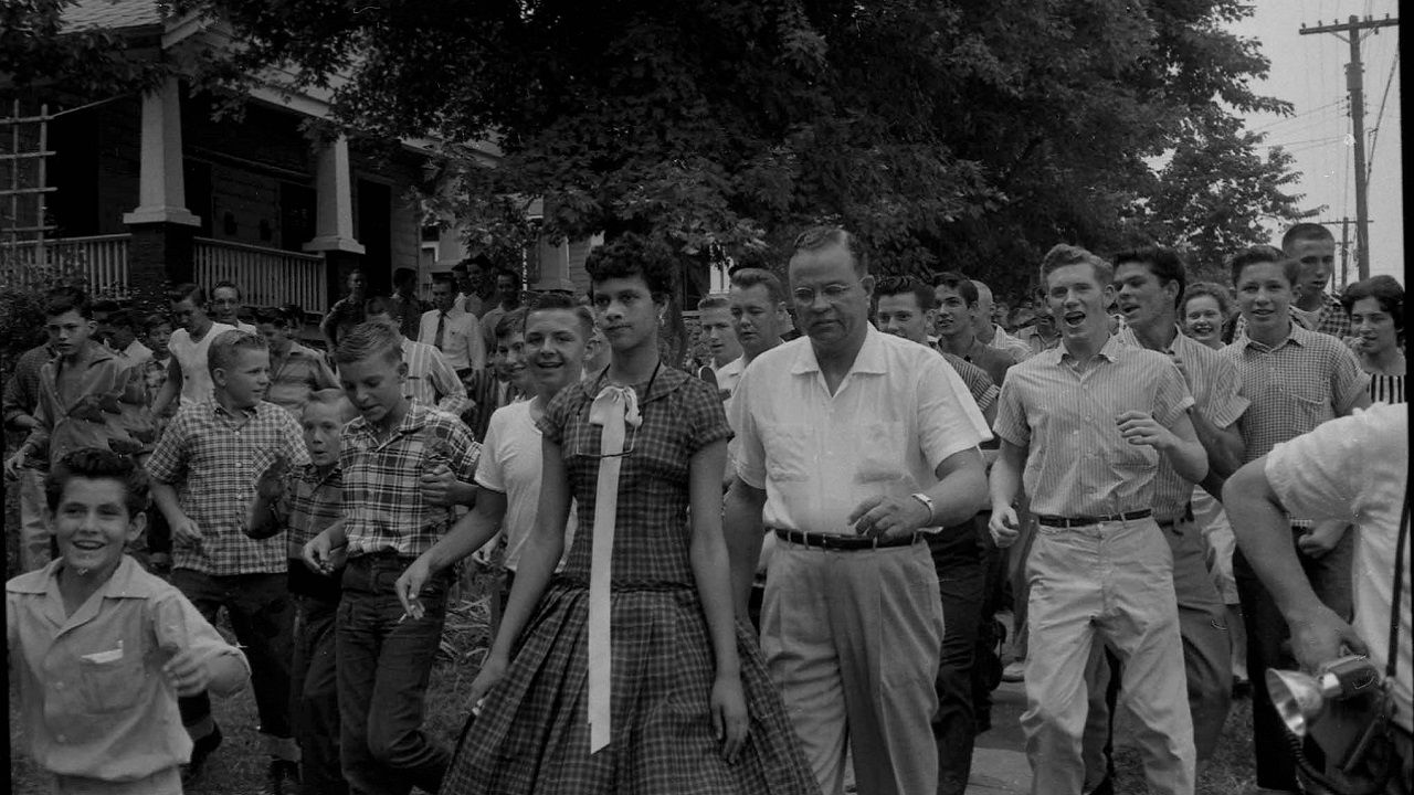Photographer Don Sturkey captured this image of Dorothy Counts-Scoggins, as she walked to enter then Harding High School. Counts-Scoggins was one of four students to first integrate an all white public school in Charlotte.
