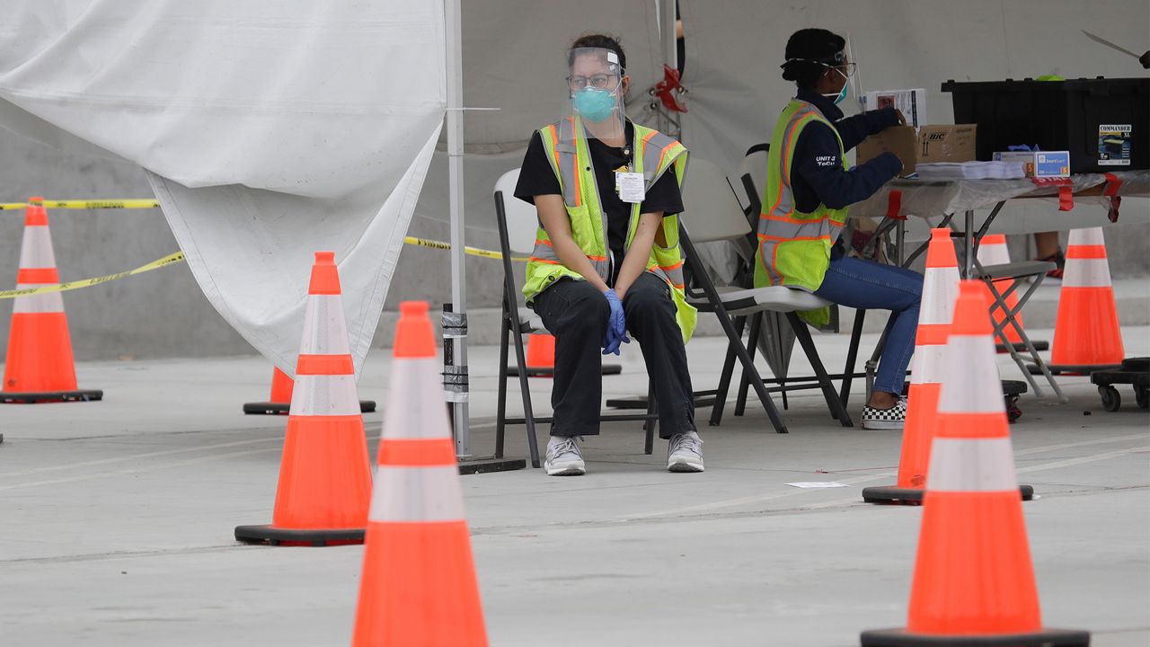 Samples are cataloged at a mobile Coronavirus testing site at the Charles Drew University of Medicine and Science Wednesday, July 22, 2020, in Los Angeles. California's confirmed coronavirus cases have topped 409,000, surpassing New York for most in the nation. (AP Photo/Marcio Jose Sanchez)