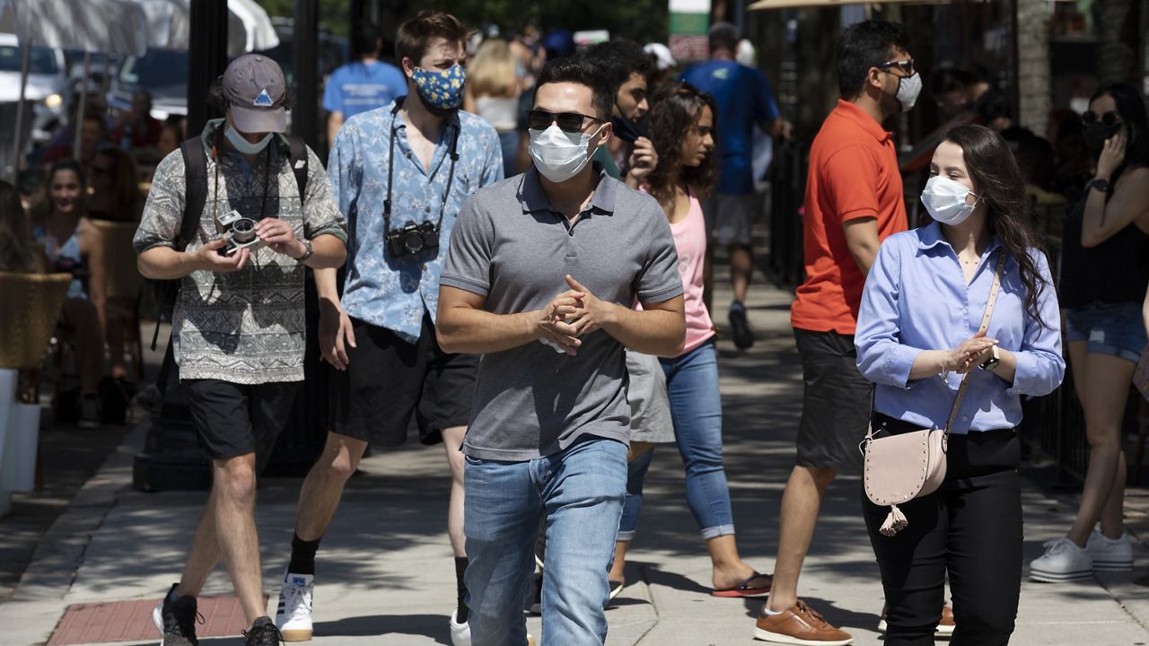 People wear protective masks in Boston on July 11, 2020 (AP Photo/Michael Dwyer, File)