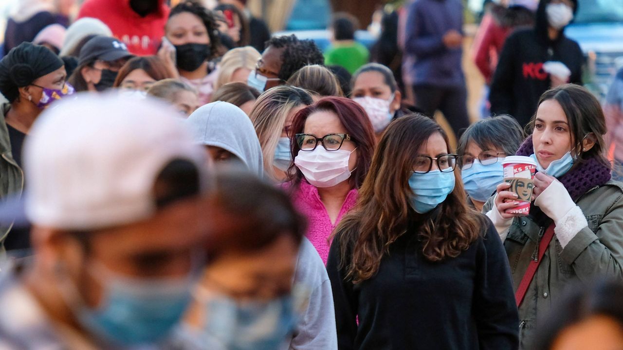 Black Friday shoppers wearing face masks wait in line to enter a store at the Citadel Outlets in Commerce, Calif., on Nov. 26. (AP Photo/Ringo H.W. Chiu, File)