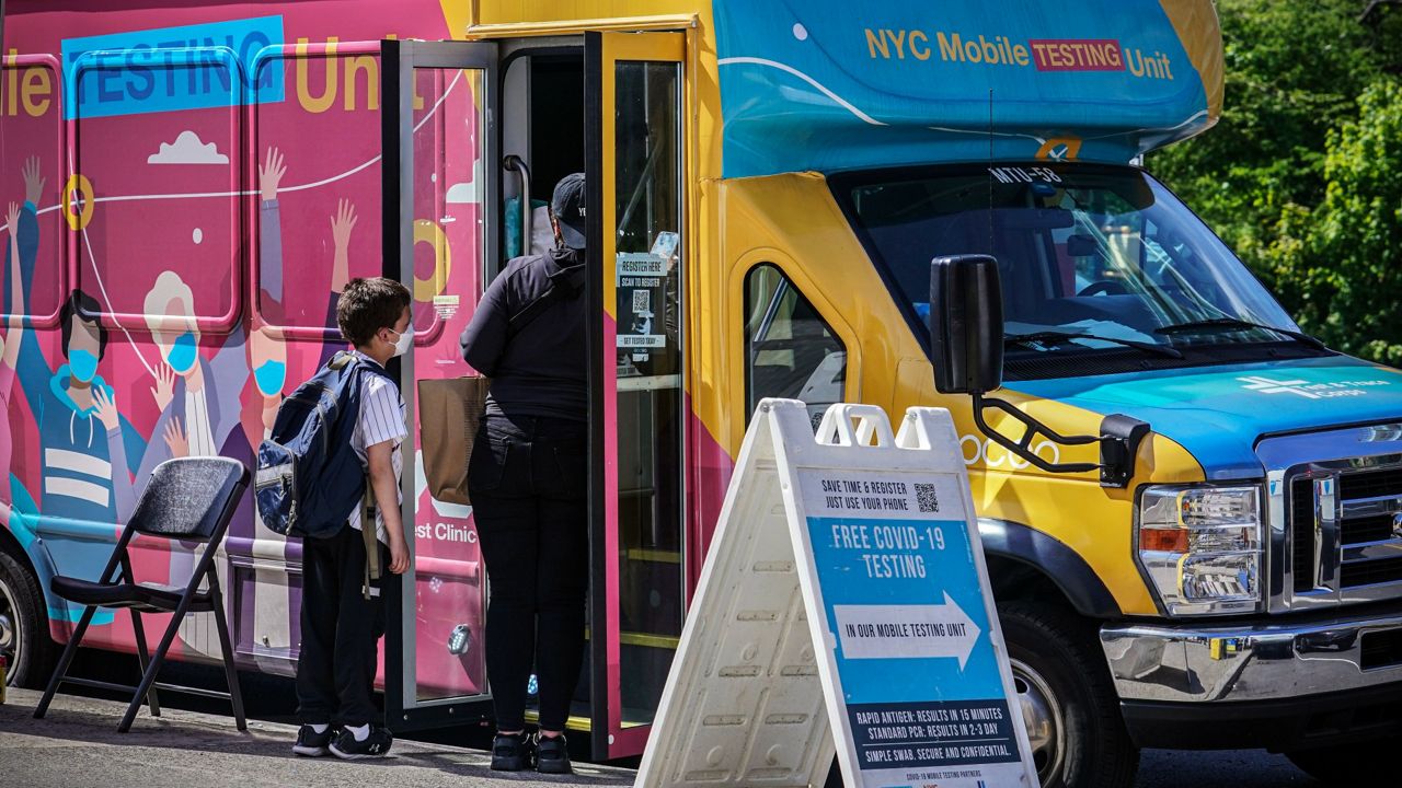 A mobile COVID-19 testing van takes walk-in clients in the Brooklyn borough of New York in May. (AP Photo/Bebeto Matthews, File)