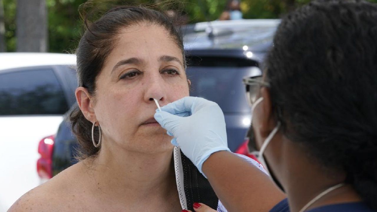 Raquel Heres gets a COVID-19 rapid test to be able to travel overseas, Saturday, July 31, 2021, in North Miami, Fla. 