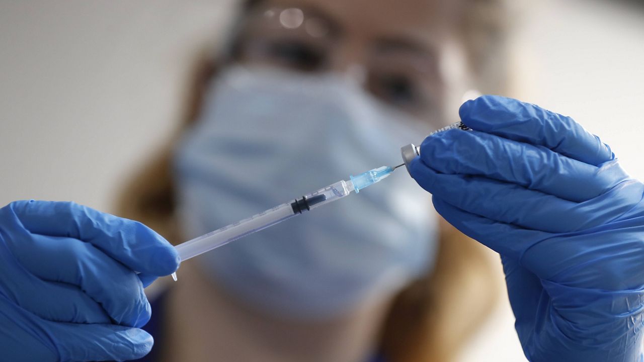 A nurse prepares a shot of the Pfizer-BioNTech COVID-19 vaccine at Guy's Hospital in London on Tuesday. (AP Photo/Frank Augstein, Pool)