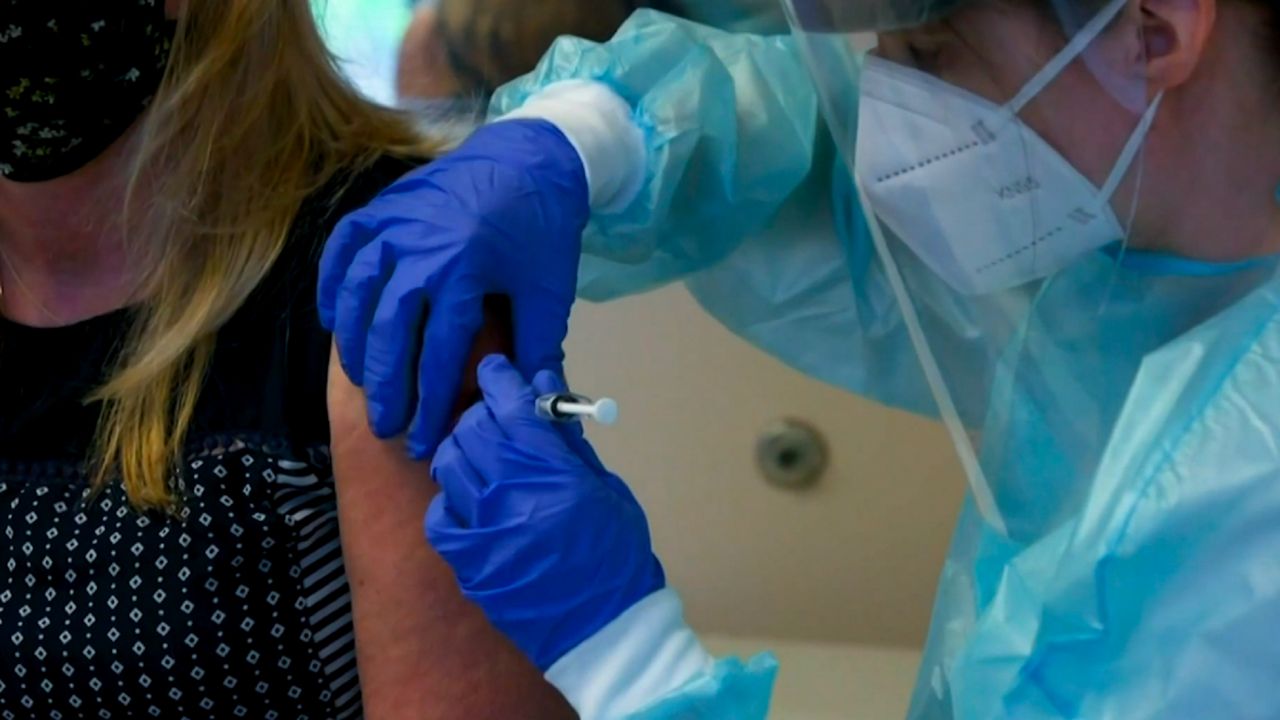 Woman getting a shot.
