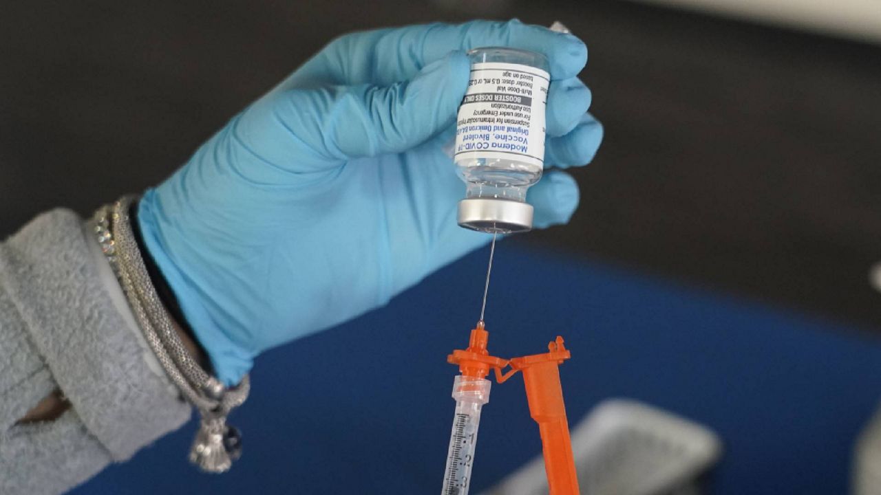 A Jackson-Hinds Comprehensive Health Center nurse loads a syringe with a Moderna COVID-19 booster vaccine at an inoculation station next to Jackson State University in Jackson, Miss., Friday, Nov. 18, 2022. Moderna recently announced early evidence that its updated booster induced BQ.1.1-neutralizing antibodies. (AP Photo/Rogelio V. Solis)