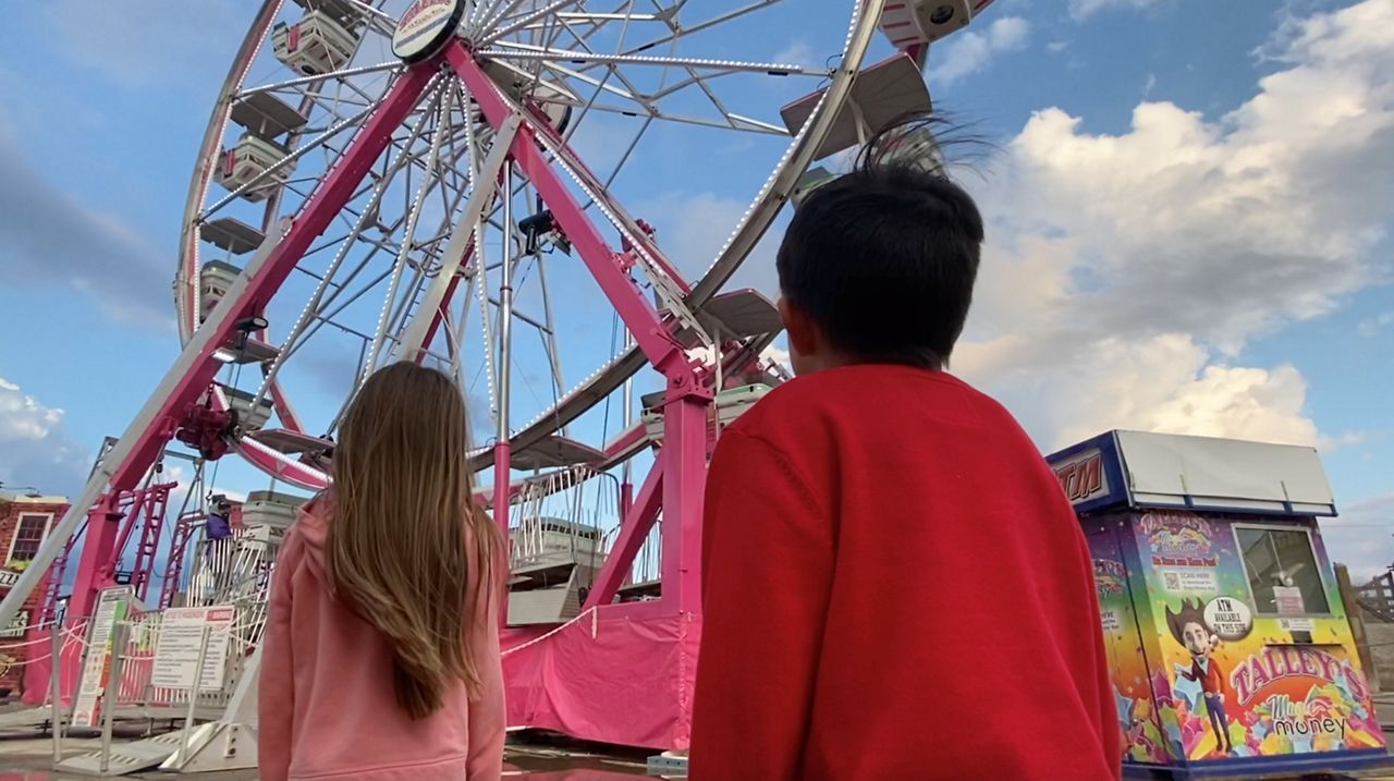 The Huerta-Jimenez children visit a carnival in Fort Worth, Texas, in this image from December 2020. (Magaly Ayala/Spectrum News 1)