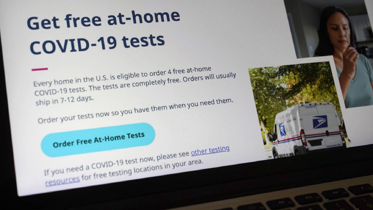 A United States government website is displayed on a computer, Wednesday, Jan. 19, 2022, in Walpole, Mass., that features a page where people can order free, at-home COVID-19 tests. The website, COVIDTests.gov, allows people to order four at-home tests per residence and have them delivered by mail. (AP Photo/Steven Senne)