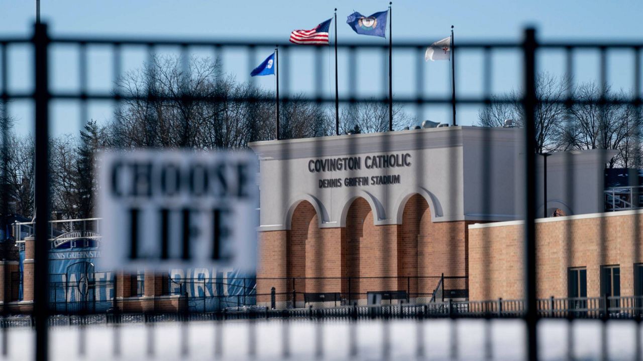 Flags fly over the Covington Catholic High School stadium in Park Kills, Ky., Sunday, Jan 20, 2019. (AP Photo/Bryan Woolston)