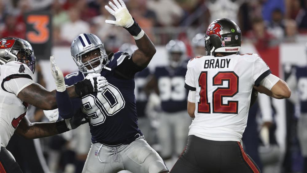 Dallas Cowboys defensive end DeMarcus Lawrence (90) pressures Tampa Bay Buccaneers quarterback Tom Brady (12) during the second half of an NFL football game Thursday, Sept. 9, 2021, in Tampa, Fla. (AP Photo/Mark LoMoglio)