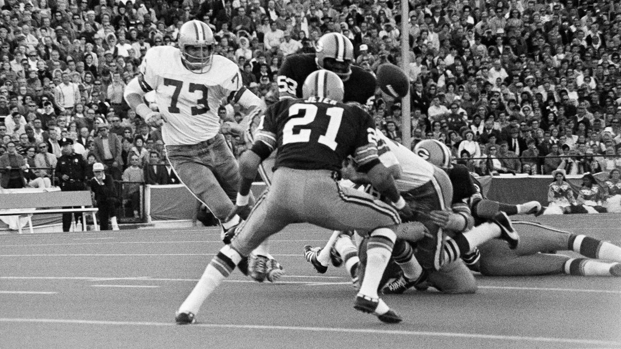 The ball squirts out of the hands of Dallas Cowboys Dan Reeves, right, as he is brought down by a Green Bay tackler during the second quarter of the game, Nov. 26, 1970, Dallas, Tex. On the play are Fred Carr (53) linebacker and Bob Jeter (21) cornerback of the Packers. Ralph Neely races in to try to get the ball, recovered by another Cowboy player. The Cowboys got a first down on the miscue. (AP Photo/Ferd Kaufman)