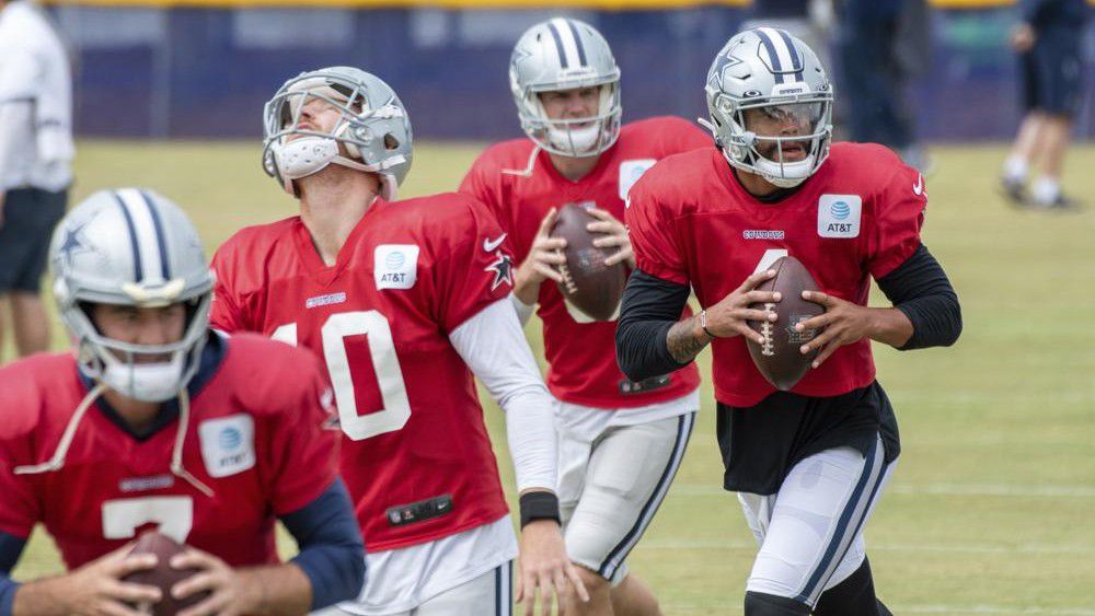 Dallas Cowboys quarterbacks Ben DiNucci, Cooper Rush, Garrett Gilbert and Dak Prescott, from left, run drills during practice at the NFL football team's training camp in Oxnard, Calif., Saturday, July 31, 2021. (AP Photo/Michael Owen Baker)