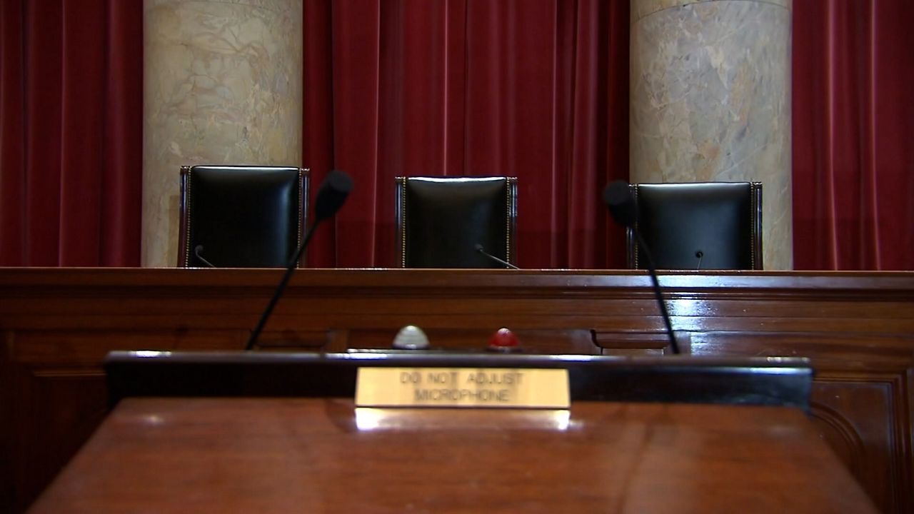 Empty seats behind U.S. Supreme Court bench in Washington, D.C.