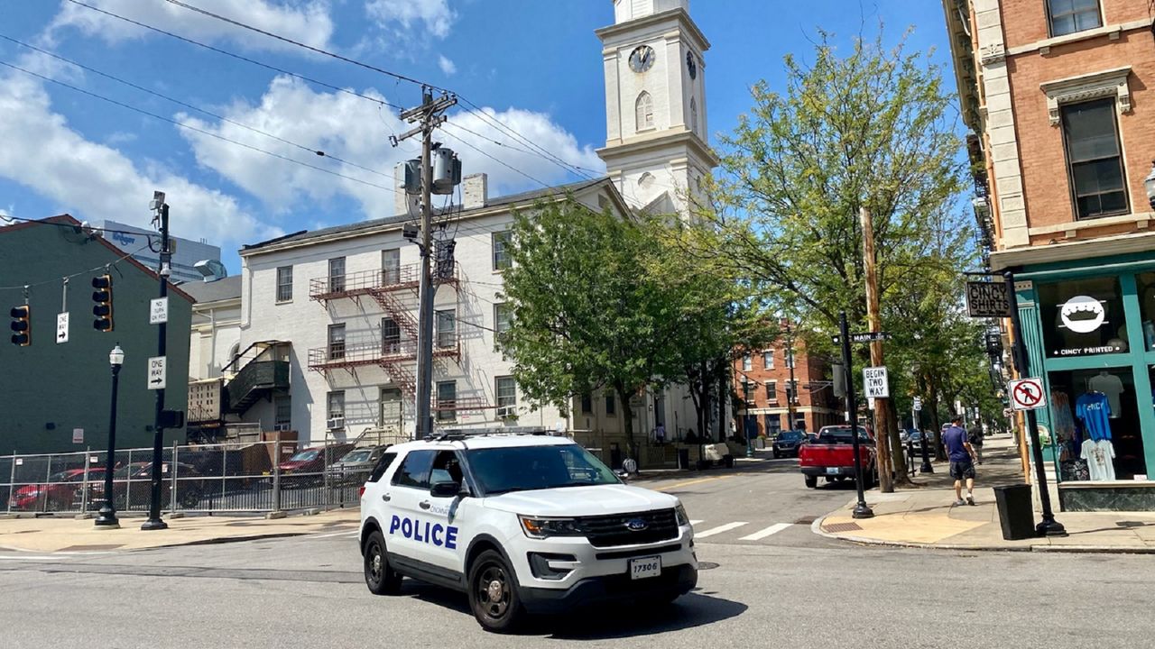 A Cincinnati Police Department officer turns onto Main Street in Over-the-Rhine. (Casey Weldon/Spectrum News 1)