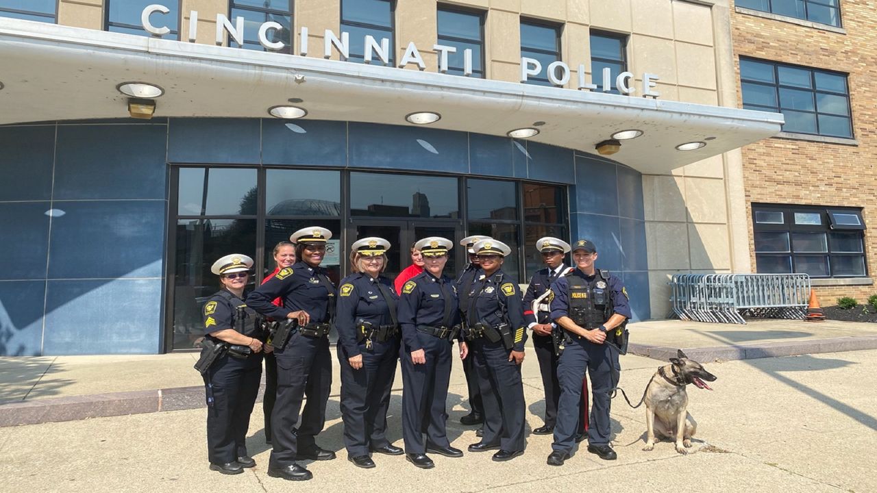 Then-Lt. Col. Teresa Theetge stands with fellow officers outside Cincinnati Police District 1 headquarters during a promotional event aimed at attracting more women to law enforcement. (Spectrum News 1/Casey Weldon)