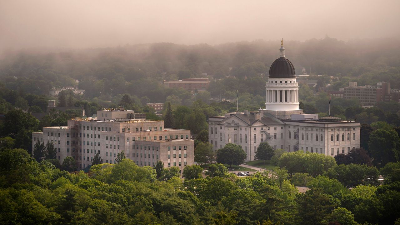 The morning fog lifts beyond the Burton M. Cross Building, left, and the State House, Wednesday, June 21, 2023, in Augusta. (AP Photo/Robert F. Bukaty)