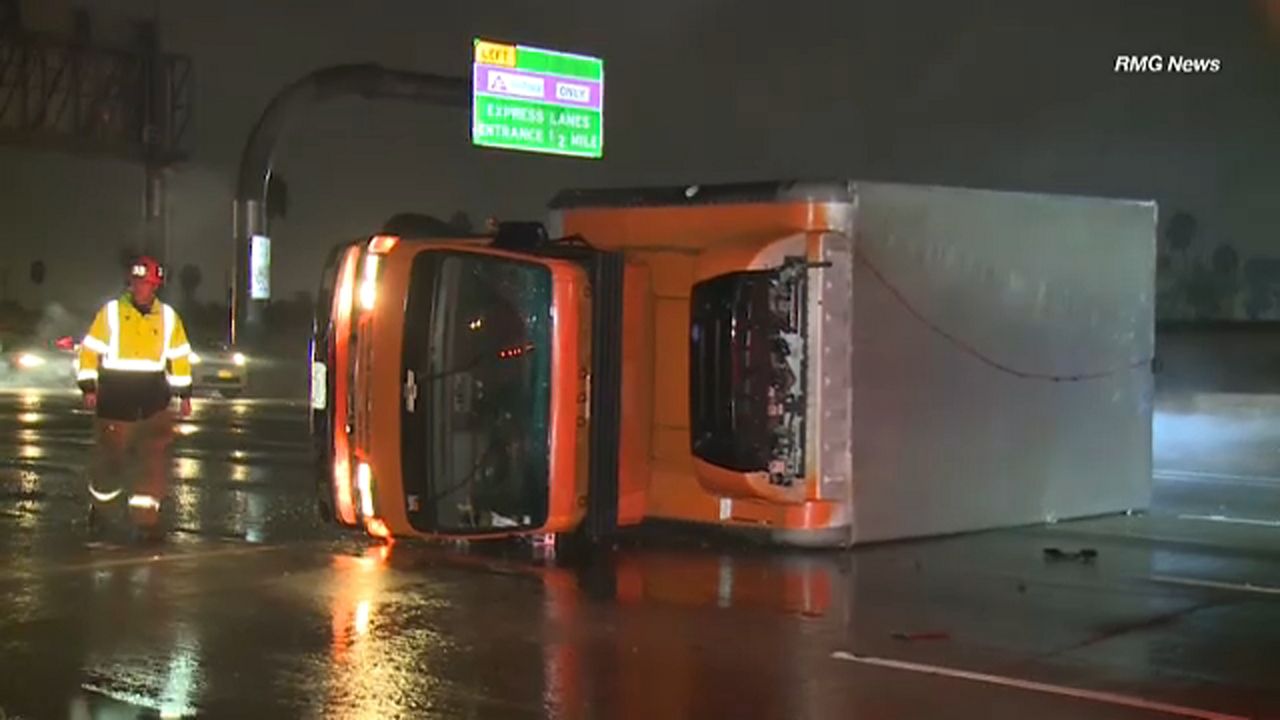 A truck overturned on a wet freeway