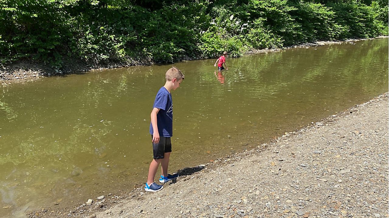 Boys walk through a creek in Ohio. (Spectrum News 1/ Jenna Jordan)