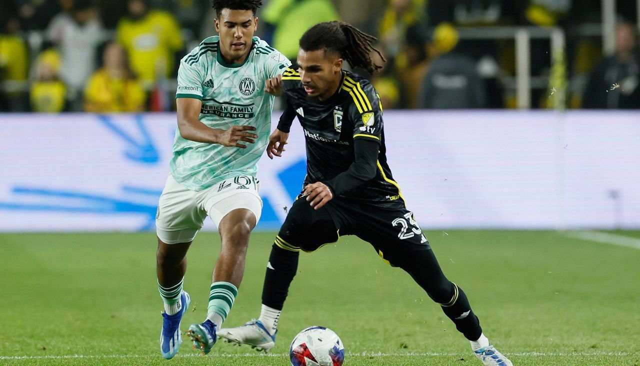 Columbus Crew's Mohamed Ramzdine Farsi, right, controls the ball as Atlanta United's Caleb Wiley defends during the first half of an MLS playoff soccer match Sunday, Nov. 12, 2023, in Columbus, Ohio. (AP Photo/Jay LaPrete)