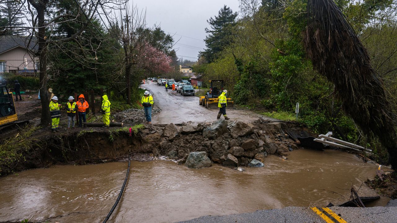 Crews assess storm damage, which washed out North Main Street in Soquel, Calif., Friday, March 10, 2023. (AP Photo/Nic Coury)