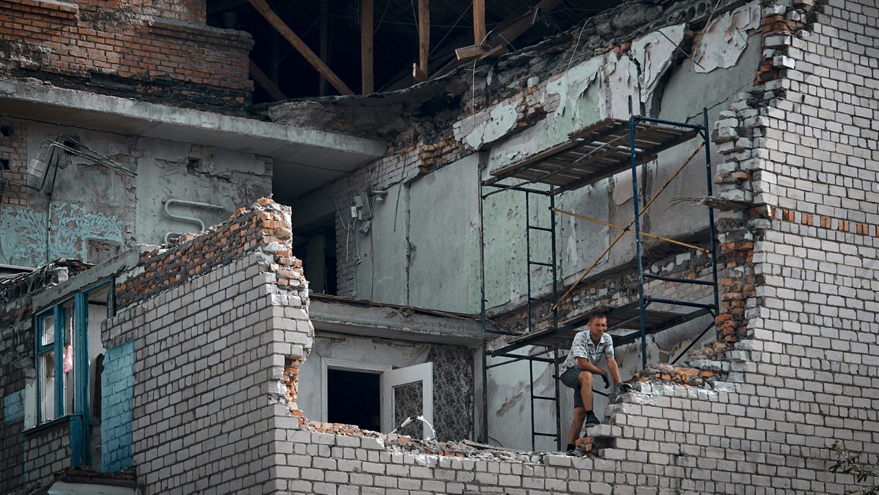 A man on Monday looks out from an apartment destroyed after Russian shelling in Nikopol, Ukraine. (AP Photo/Kostiantyn Liberov)