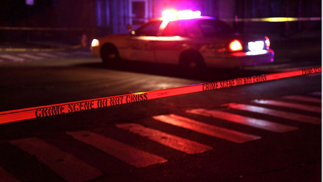 A police car near crime scene tape. (Getty Images)