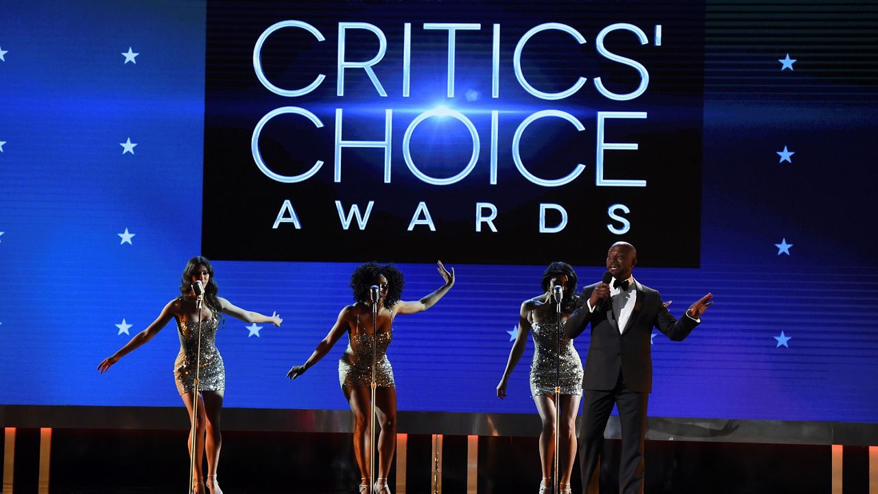 Host Taye Diggs, right, performs at the 25th annual Critics' Choice Awards on Sunday, Jan. 12, 2020, at the Barker Hangar in Santa Monica, Calif. (AP Photo/Chris Pizzello)