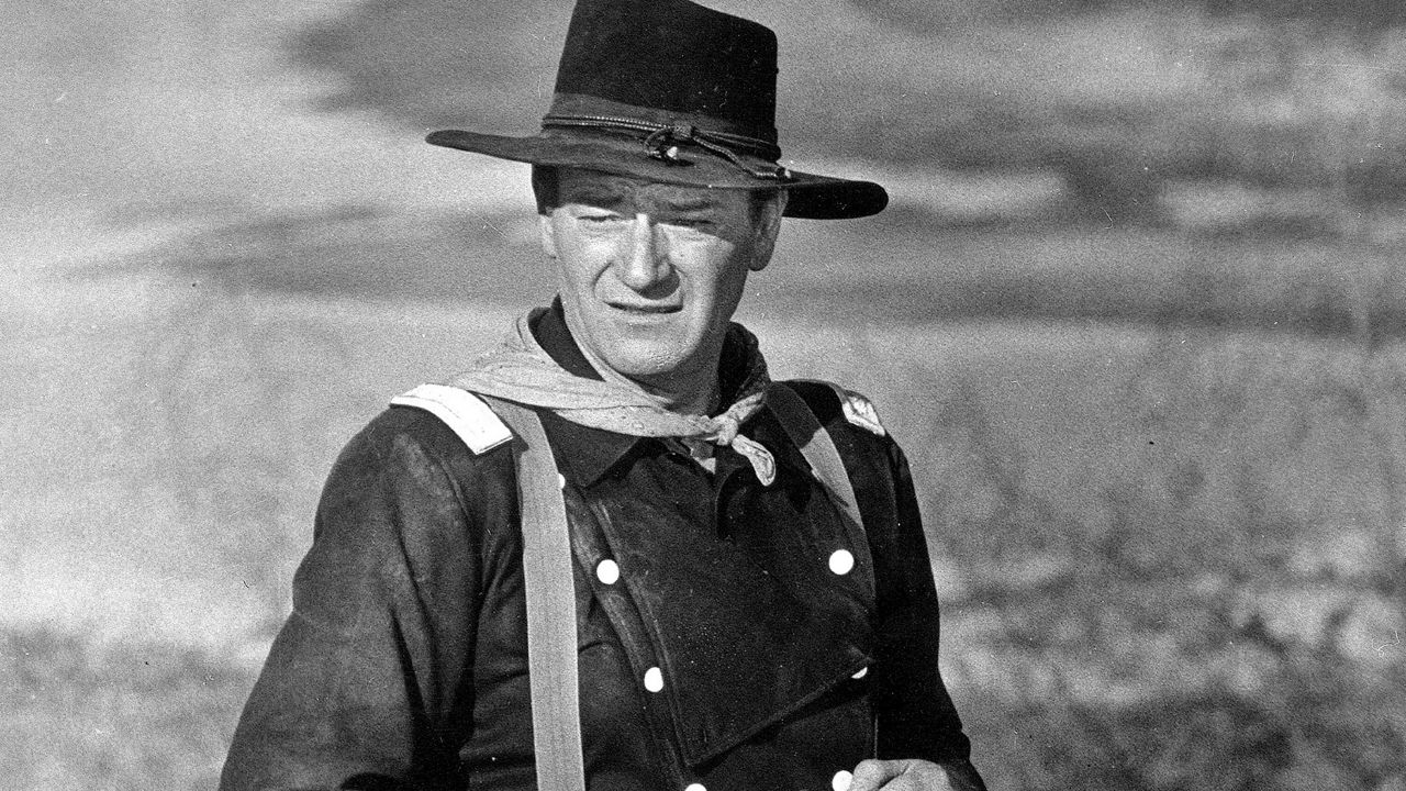 FILE - In this undated photo, John Wayne appears during the filming of "The Horse Soldiers." In the latest move to change place names in light of U.S. racial history, leaders of Orange County’s Democratic Party are pushing to drop film legend Wayne’s name, statue and other likenesses from the county’s airport because of his racist and bigoted comments. (AP Photo, File)