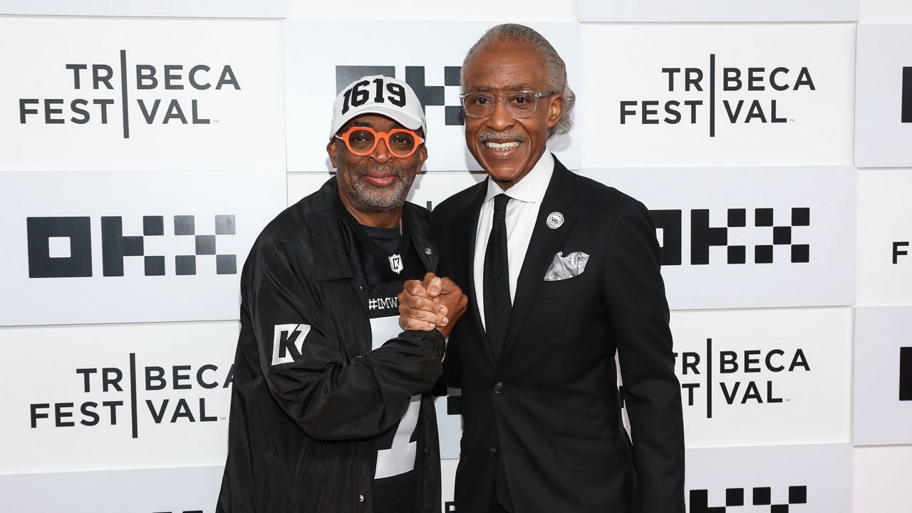Director Spike Lee, left, and journalist Al Sharpton, right, who are both dressed in black, attend the premiere for "Loudmouth" at the BMCC Tribeca Performing Arts Center during the 2022 Tribeca Festival on Saturday, June 18, 2022, in New York.