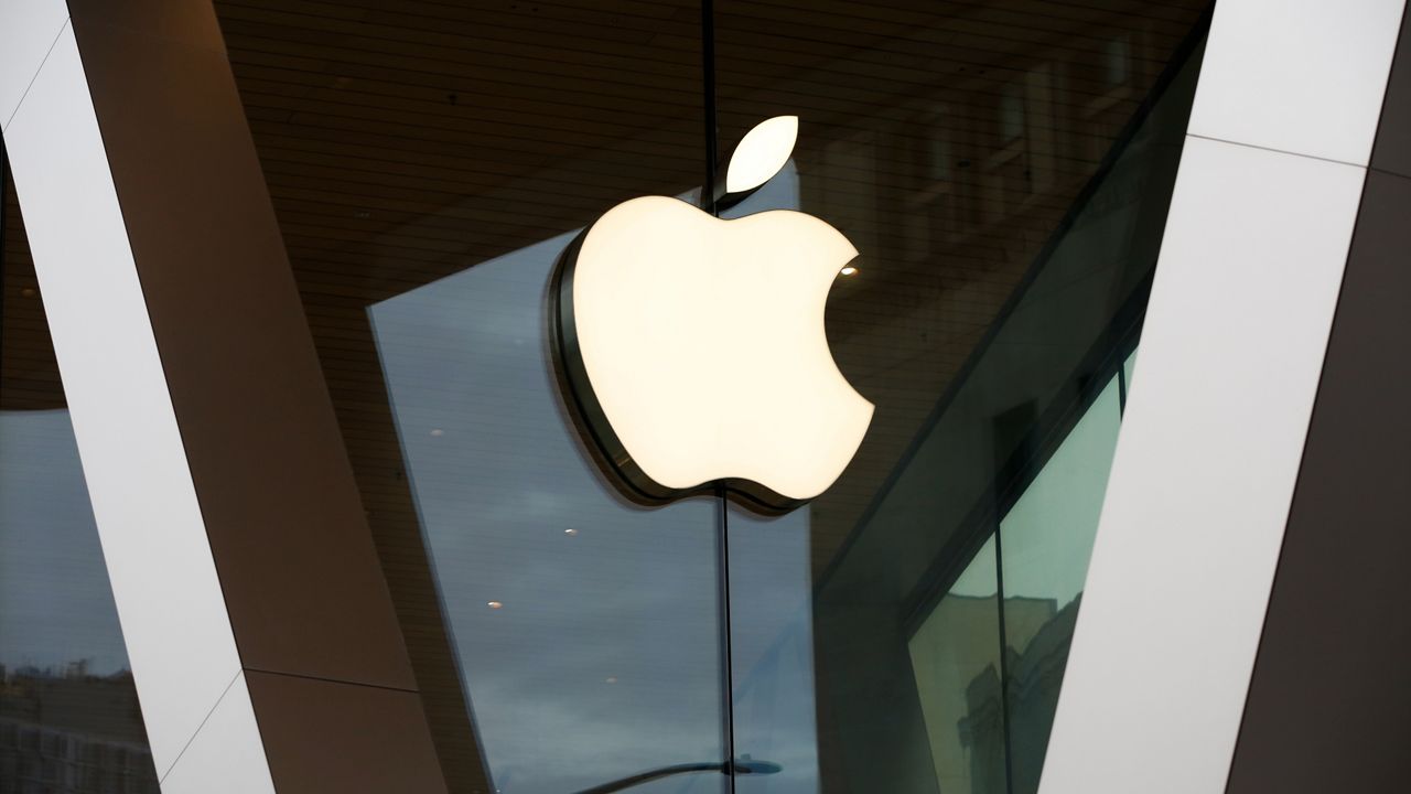 The Apple logo adorns the facade of a retail store. (AP Photo/Kathy Willens, File)