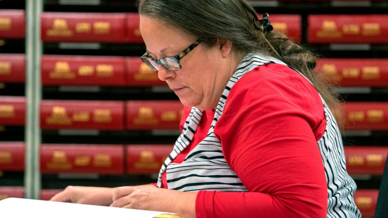 In this Nov. 6, 2018, file photo, Kim Davis, the county clerk for Rowan County in Kentucky, works with the county election board on Election Day, in Morehead, Ky. A federal judge has ruled, Friday, March 18, 2022, that the former Kentucky clerk violated the constitutional rights of two same-sex couples after she wouldn't issue them marriage licenses — a refusal that sparked international attention and briefly landed her in jail in 2015. (AP Photo/John Flavell, File)