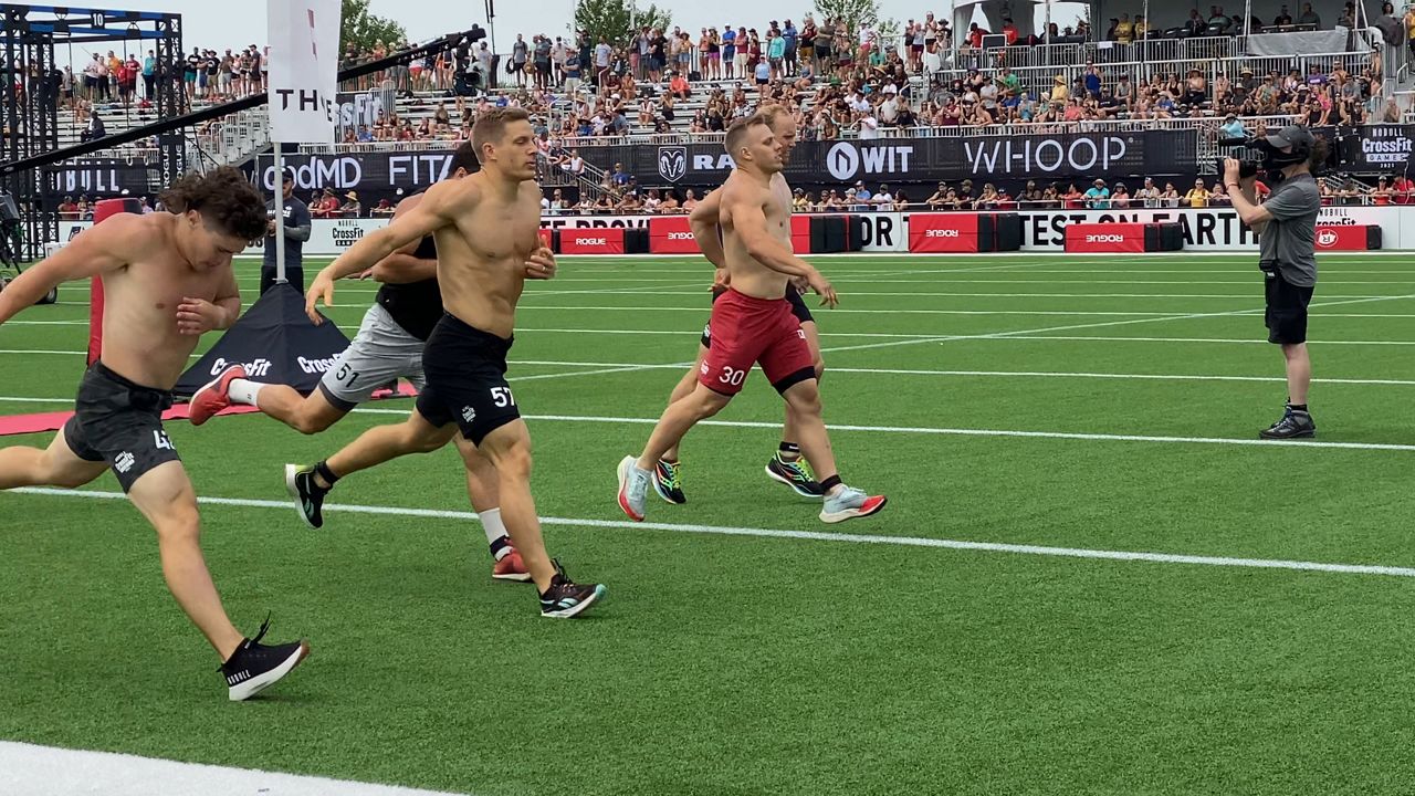 Men running right after crossing finish line