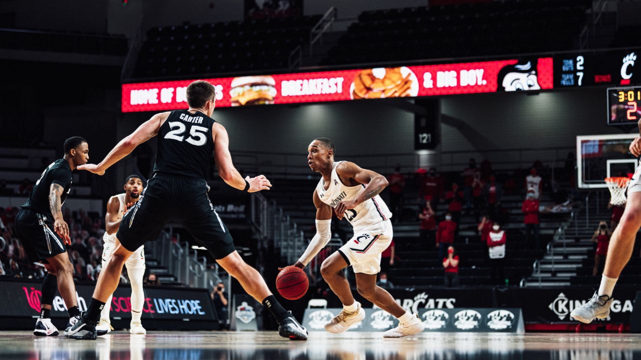 A University of Cincinnati basketball player dribbles the ball at Fifth Third Arena while being guarded by a Xavier University player. It took place during the 2020 Crosstown Shootout in Cincinnati. (Photo courtesy of University of Cincinnati Athletics)