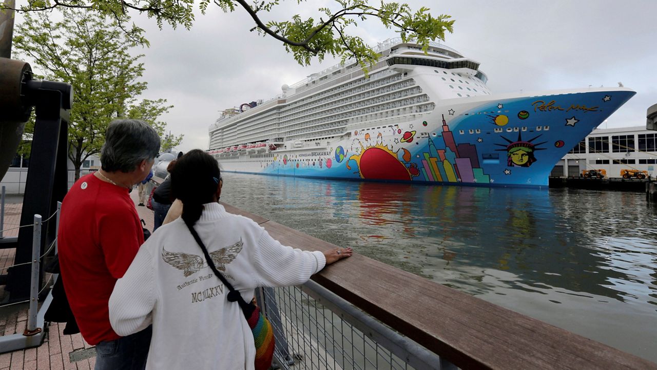  People pause to look at Norwegian Cruise Line's ship, Norwegian Breakaway, on the Hudson River, in New York, on May 8, 2013. (AP Photo/Richard Drew, File)