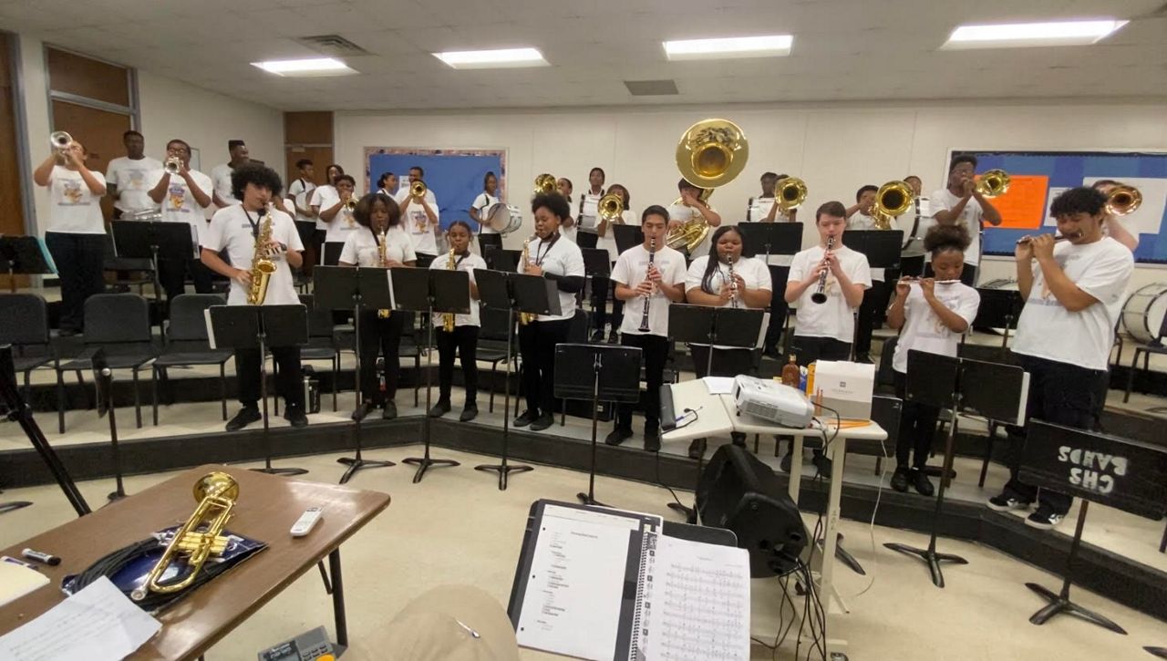 The Hugh Cummings High School band practices before the start of the school day. (Spectrum News 1/Zyneria Byrd)