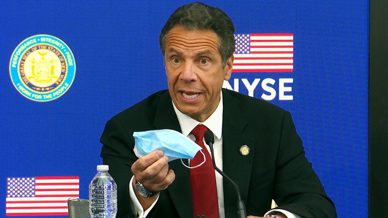 Governor Cuomo holding a mask